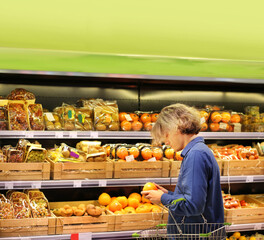 Young man buying vegetables and fruits at the market..