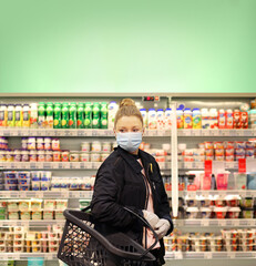Supermarket shopping, face mask and gloves,Woman choosing a dairy products at supermarket.