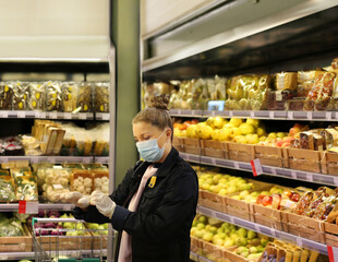 Supermarket shopping, face mask and gloves,woman buying fruits at the market.