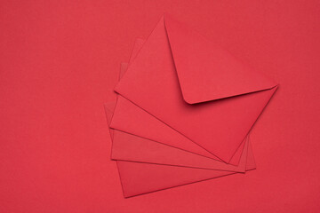Top above overhead close up view photo of heap fan of red bright color envelopes isolated bright color desk