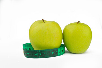 green apples with measuring centimeter for weight control