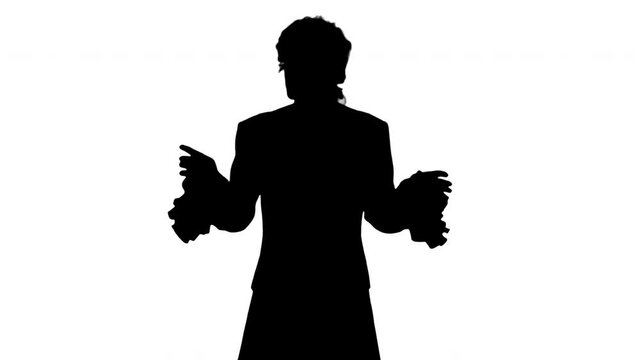 Silhouette Man in old-fashioned frock coat and white wig talking and waiving with his hands theatrically looking at camera.