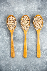 White kidney beans in blue bowl and wooden spoons