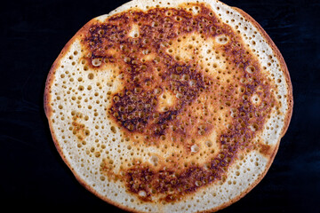 delicious beautiful Russian pancakes on a black background