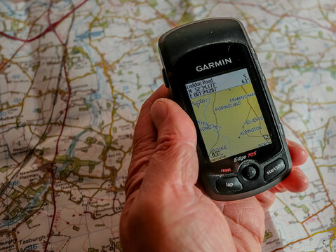 Norwich, Norfolk, UK – December 24 2020. An illustrative editorial photo of an unidentifiable human holding a Garmin Edge 705 GPS device whilst planning a route