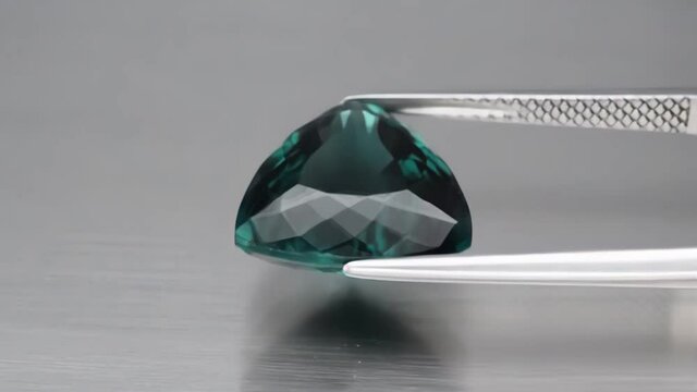 natural blue tourmaline indicolite on the grey background