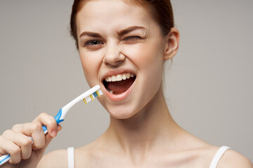 woman in white t-shirt toothbrush smile health and hygiene
