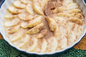 Freshly baked Apple pie on the table with apples, piece in plate on dark table background, autumn apples, wood background