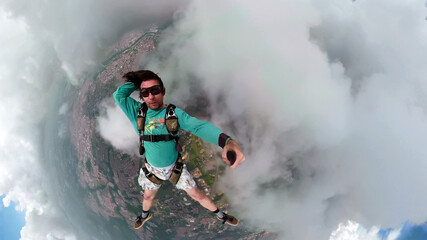 Unique images of a parachutist making selfie. Used a special camera with fish eye lens.