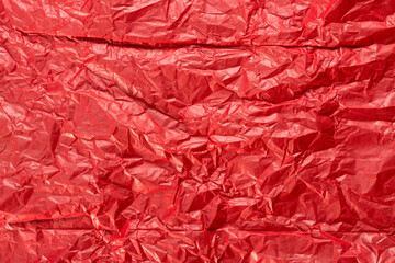 Bright red wrapping paper crumpled paper texture. Creased sheet background. Textured effect.