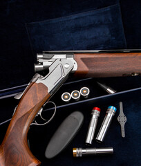 Double-barreled shotgun on a dark blue velvet back. Smooth-bore weapons with vertical barrels. A...