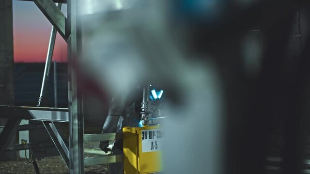Space man. Evening view at the astronaut walking on between photovoltaic power units while examining ecological technologies. Man working at sun energy farm. Renewable energy. Sustainable production