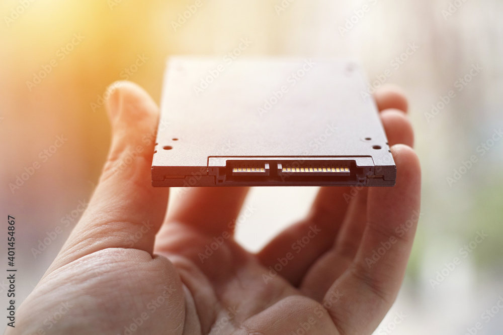 Aufkleber solid state disk drive or ssd close up. person holding data storage device computer hardware