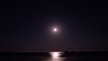 Fototapeta na wymiar night sky with stars and moon on the sea