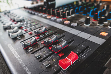 Obraz premium Od adjusters of a mixing console, sound mixer. It is used for audio signals modifications to achieve the desired output. Applied in recording studios, broadcasting, television.