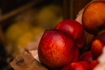 red peach in wooden box in market
