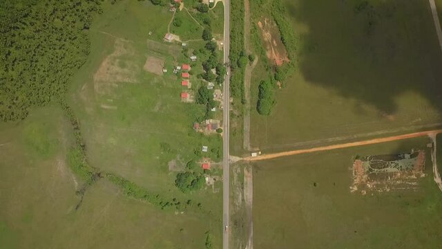 Birdseye view of a straight road across a green savanna