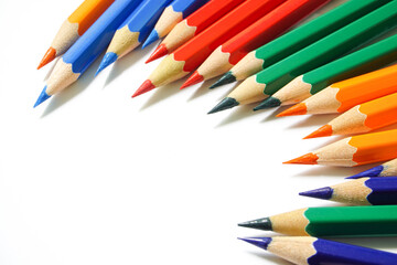 Colored pencils arranged in multiple colors on a white background