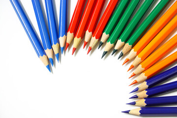 Colored pencils arranged in multiple colors on a white background