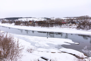 The spring river in the village began to thaw from the ice.The ice in the river began to melt.