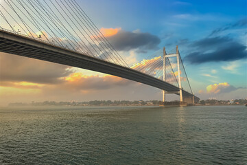 Fototapeta na wymiar Vidyasagar Setu cable stayed bridge on river Ganges at Kolkata at sunset with moody sky. 