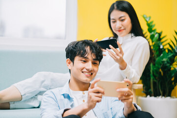 Asian couple playing games at home together, the happy life of a newlyweds