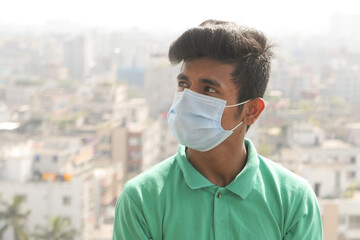  young man with protective face mask at city 