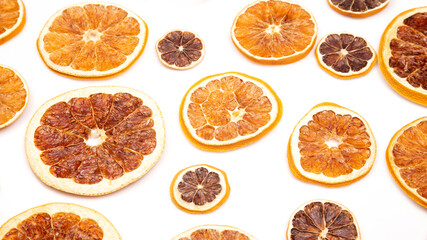 mix of different pieces of dried citrus fruit on white background