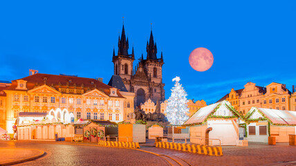 Fototapeta na wymiar The Christmas tree and market in the Old Town Square with full moon - Prague