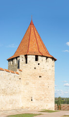 Tower of an ancient fortress with red tiled roofs