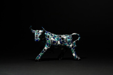 Horizontal close-up subject photo of an isolated single ceramic souvenir toy of a fighting bull on...