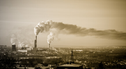 Sepia, blurred car factory smoke comes from huge factory chimneys. Concept: ecology and industry. Pollution of the environment. Harmful emissions into the atmosphere.