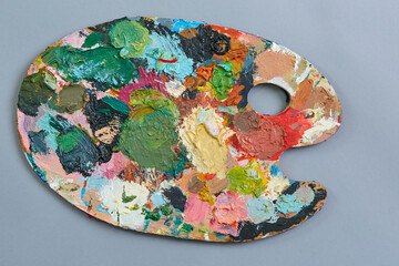 Artist's palette with different colors, on a gray background