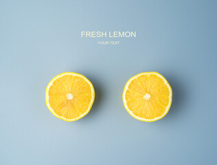 Two halves of a ripe juicy lemon on a gray background. Top view with space to copy. The concept of...
