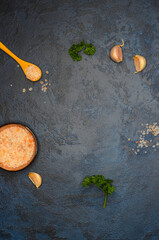 culinary background with copy space for text, parsley greens, pink himalayan and garlic salt,...