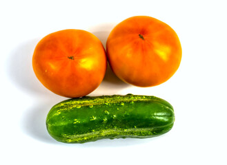 Stock Foto Closeup of yellow orange tomato and cucumber isolated on white background