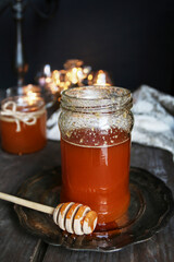 A jar of honey among Christmas decorations.