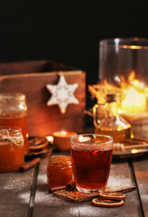 Glass of Christmas tea with cloves and cinnamon.