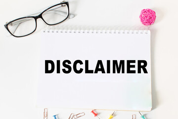 Notepad with inscriptions DISCLAIMER on a white background. business concept.