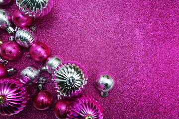 Christmas balls composition decoration ornaments with space copy on pink glitter background
