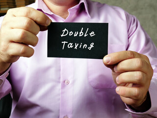 Business concept about Double Taxing with inscription on the sheet.