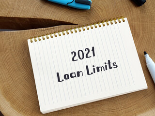 Financial concept meaning 2021 Loan Limits with phrase on the piece of paper.