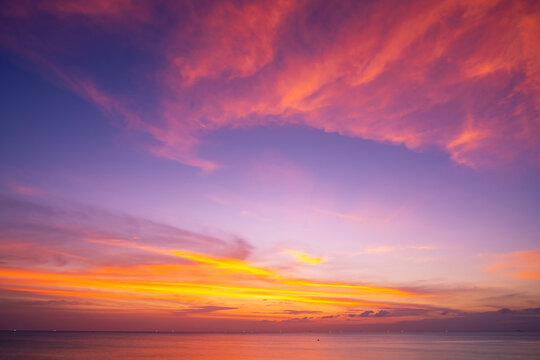 Landscape Long exposure of majestic clouds in the sky sunset or sunrise over sea with reflection in the tropical sea Beautiful cloudscape scenery Amazing light of nature Landscape © panya99