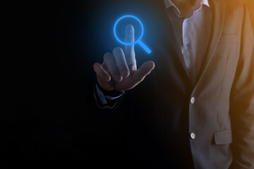 Businessman, man hold in hand magnifying glass icon.business, technology and internet concept
