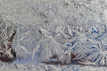 Frost patterns on the frozen window. Hoarfrost background, frost texture, Christmas pattern on...