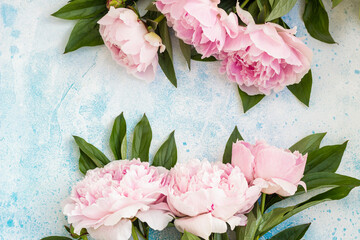 Bouquet of beautiful pink peonies, blue background. Top view. Flowers texture. Copy space.