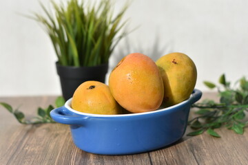 fresh mango in blue bowl  