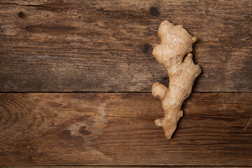 Close up of fresh ginger root spice on wooden table
