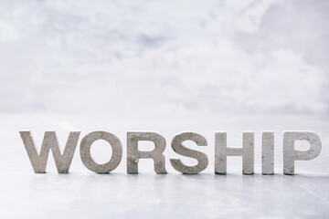 Word Worship made with cement letters on grey marble background. Copy space. Biblical, spiritual or christian reminder. Good friday, Easter day in church. Christian music concert, Sunday service