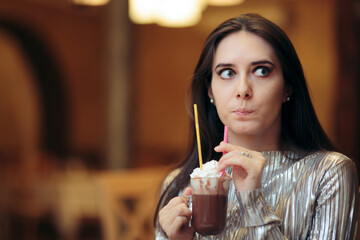 Unhappy Girl Drinking a Hot Chocolate Beverage at a Party